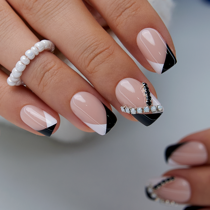 Nude French medium squoval press-on nails worn on a hand