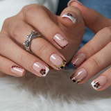Nude Leopard short squoval press-on nails worn on a hand
