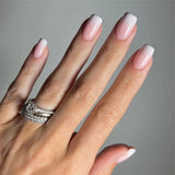 Nude Pink short squoval Ver 2 press-on nails worn on a hand