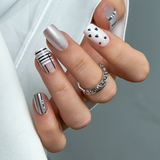Nude Spark Line medium squoval press-on nails worn on a hand