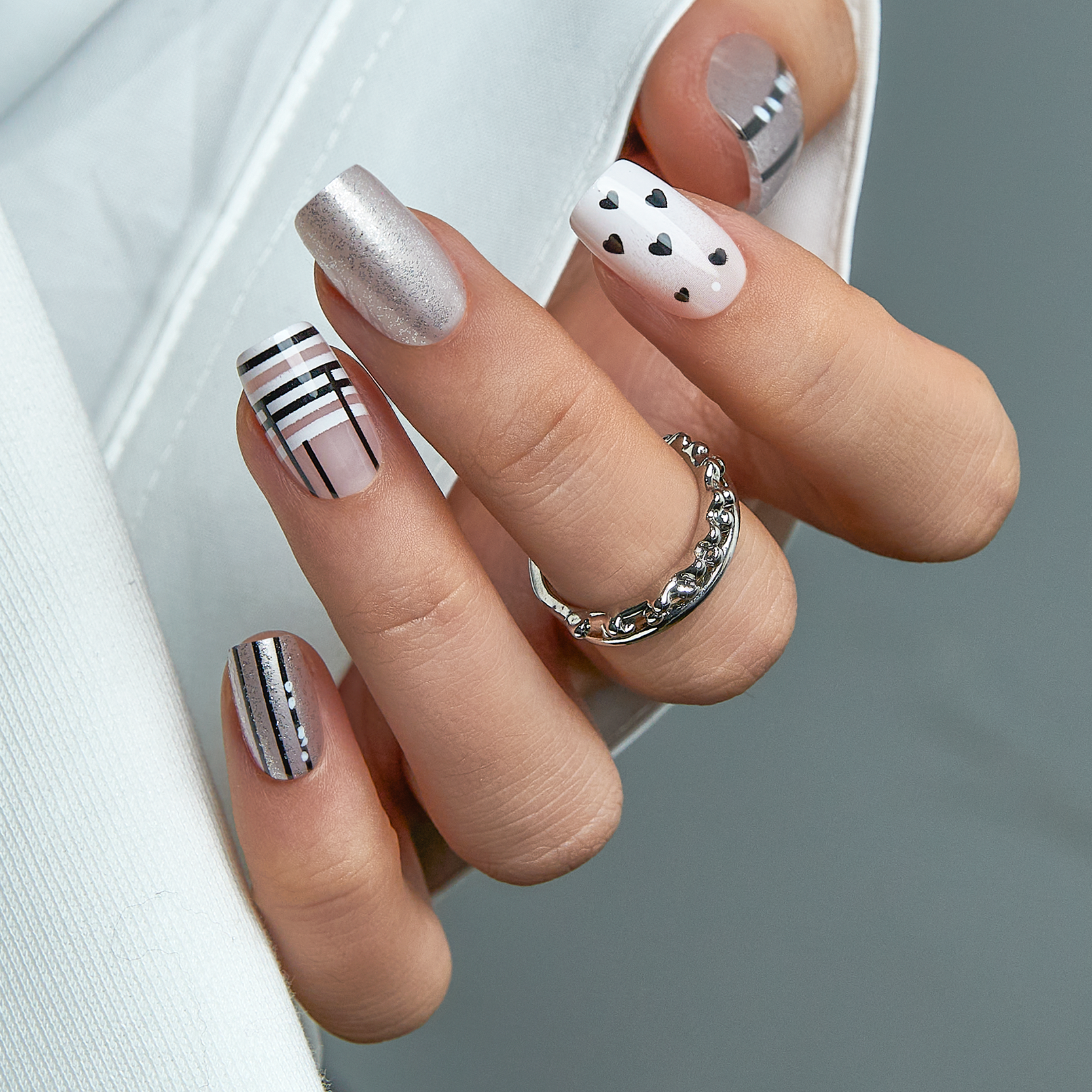 Nude Spark Line medium squoval press-on nails worn on a hand