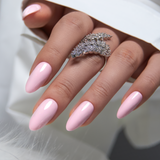 Pink Aura L stiletto press-on nails worn on a hand