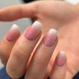 Pink Drift medium squoval press-on nails worn on a hand
