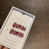 Lirenail press-on nails packaging with pink and red tones covered in clear and pink crystal gems