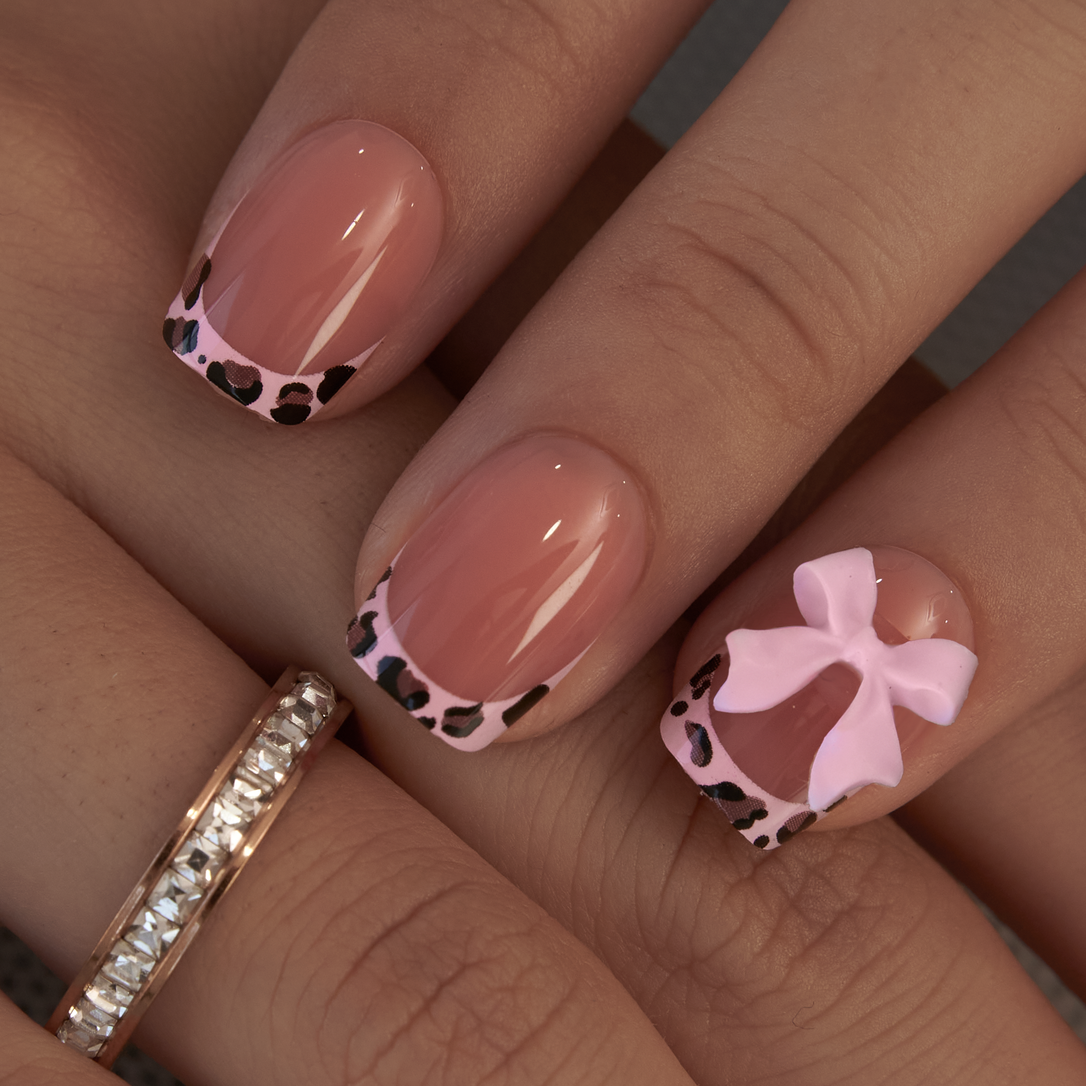 Pink Safari short squoval press-on nails worn on a hand