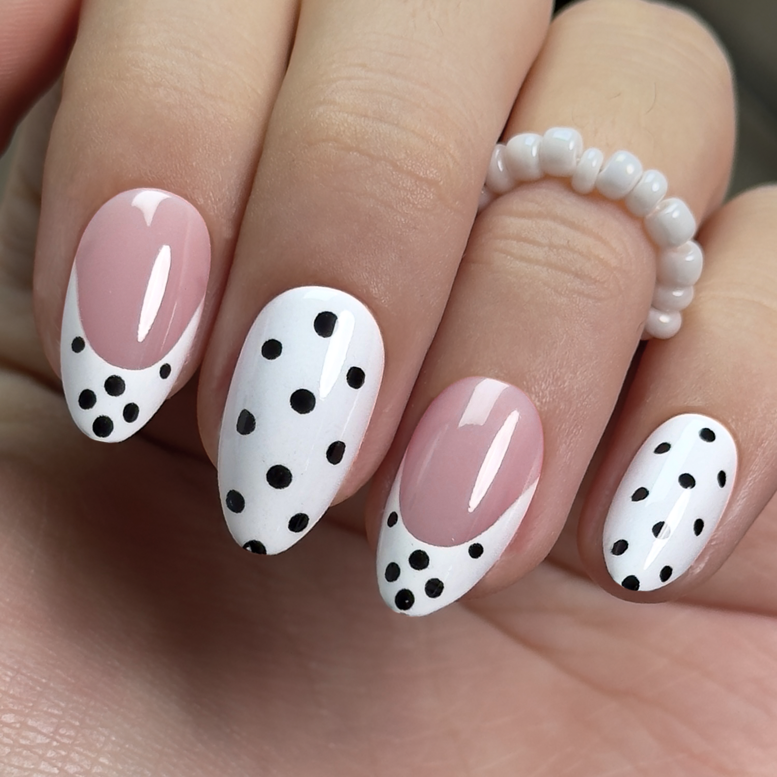 Playful French short almond press-on nails worn on a hand