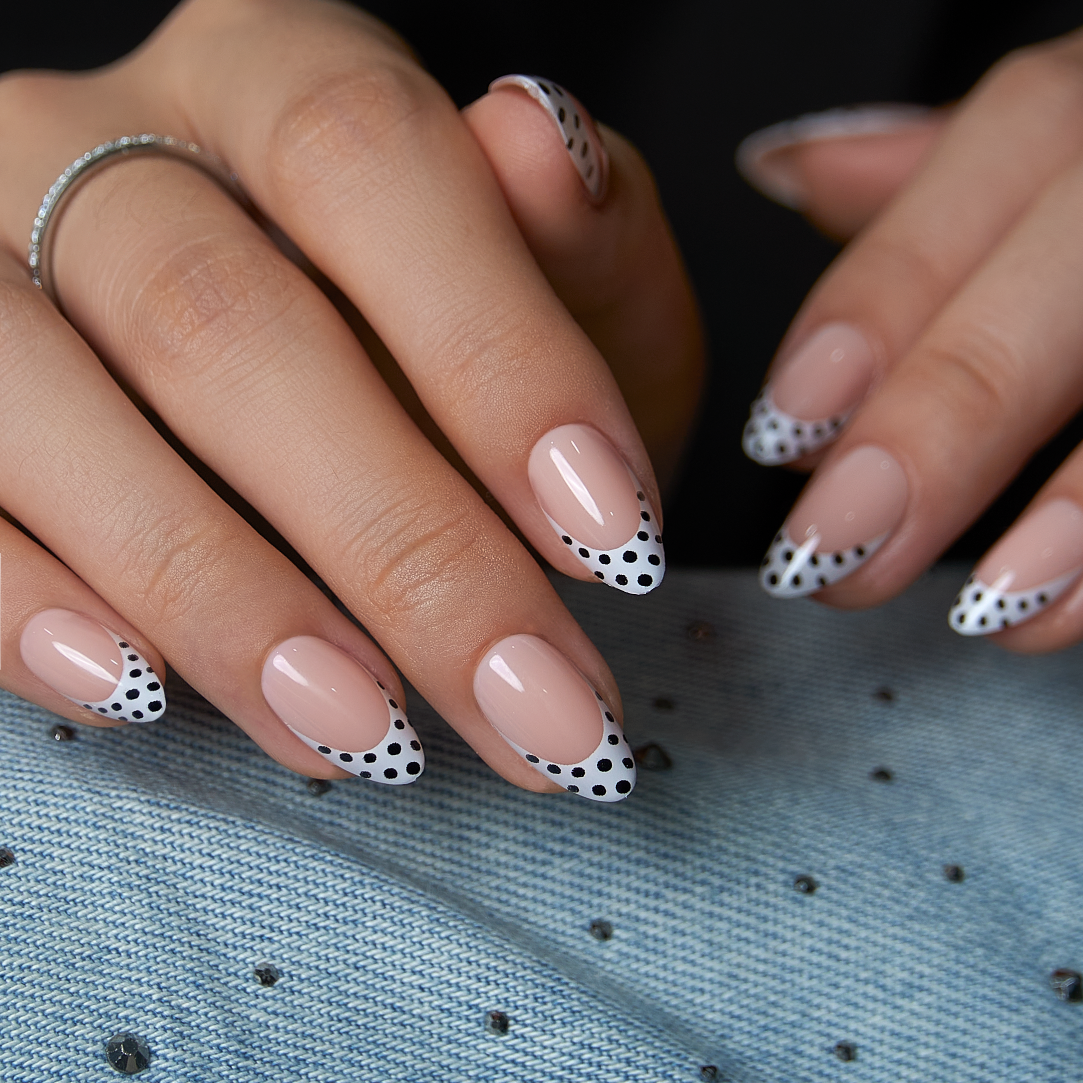 Polka Grace short almond press-on nails worn on a hand
