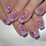 Purple Blossom short squoval press-on nails worn on a hand