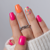 Rainbow Petal short squoval press-on nails worn on a hand