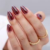 Red Mirror Glam short almond press-on nails worn on a hand