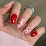 Ribbon Love short almond press-on nails worn on a hand