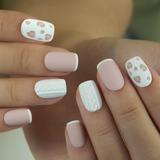 Romance Sweater short squoval press-on nails worn on a hand