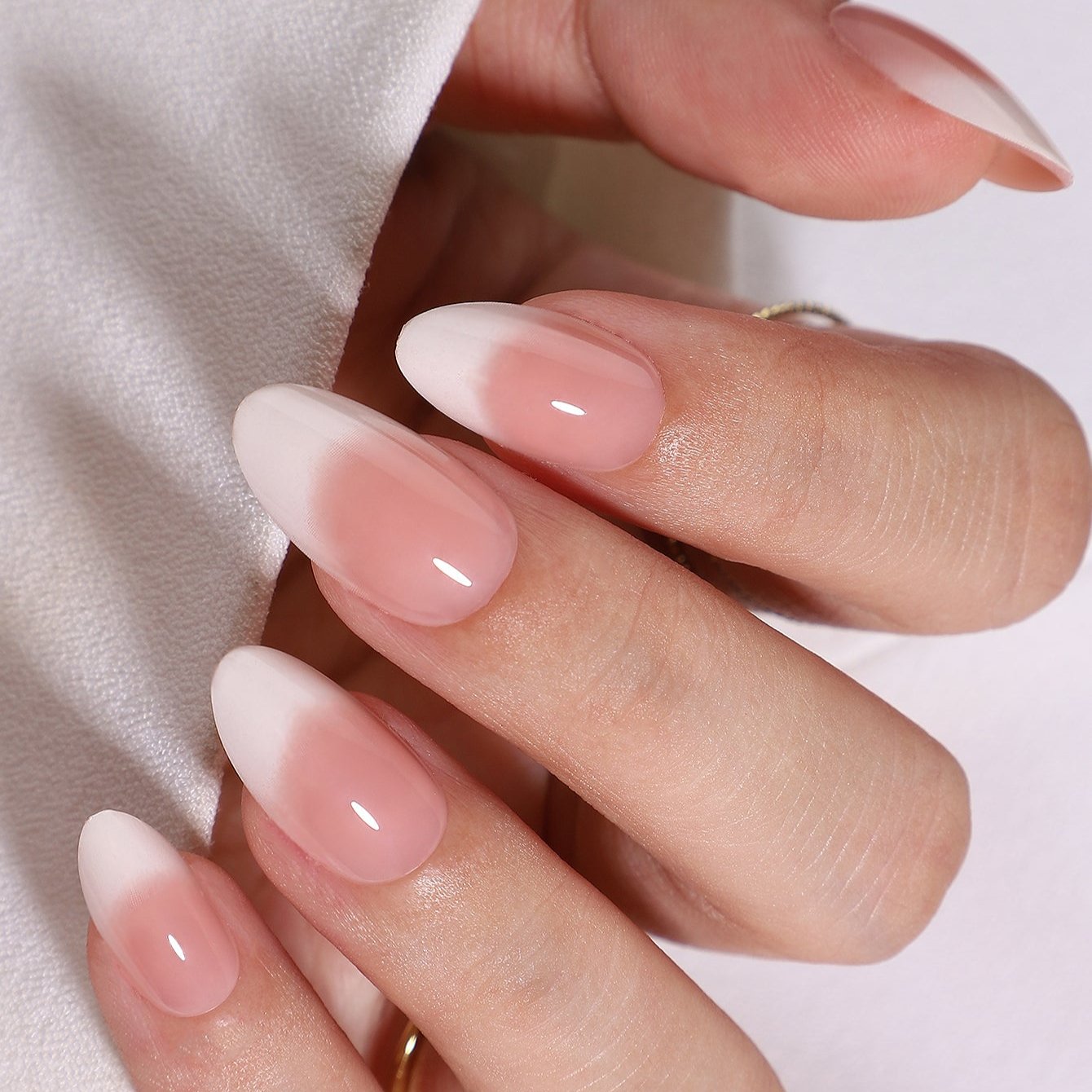 Romantic Roam short almond press-on nails worn on a hand
