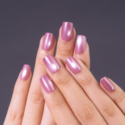 Rose Aurora short squoval press-on nails worn on a hand
