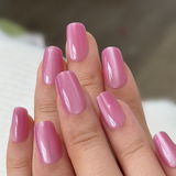 Rosy Glow medium squoval press-on nails worn on a hand