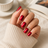 Ruby Cat Eye short square press-on nails worn on a hand