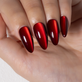 Ruby Cat Glow long almond press-on nails worn on a hand