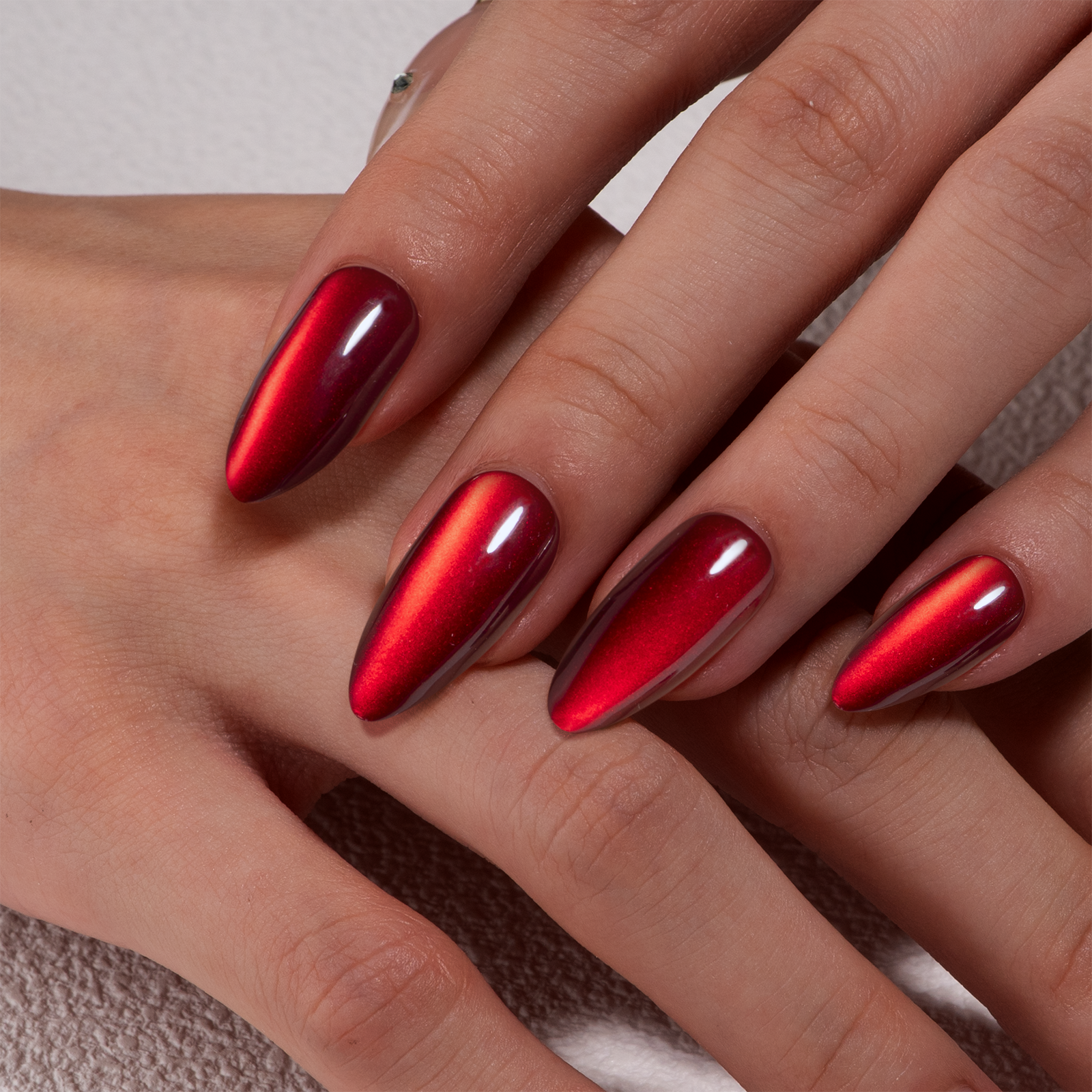 Ruby Cat Glow long almond press-on nails from the side