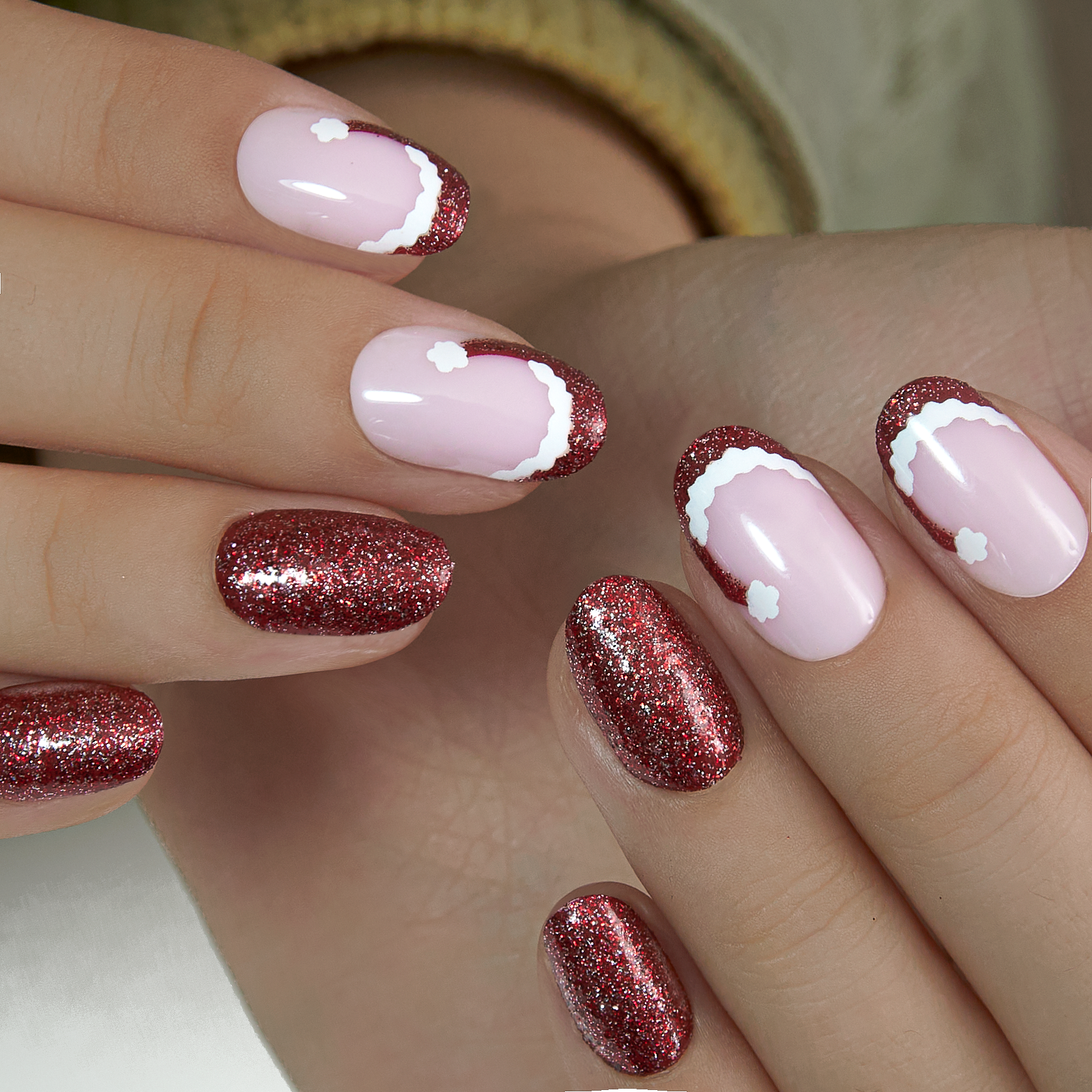 Ruby Charm medium oval press-on nails worn on a hand