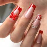 Ruby Gift long square press-on nails worn on a hand