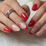 Ruby Polka medium oval press-on nails worn on a hand
