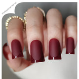 Ruby Tip Charm M Duckbill press-on nails worn on a hand