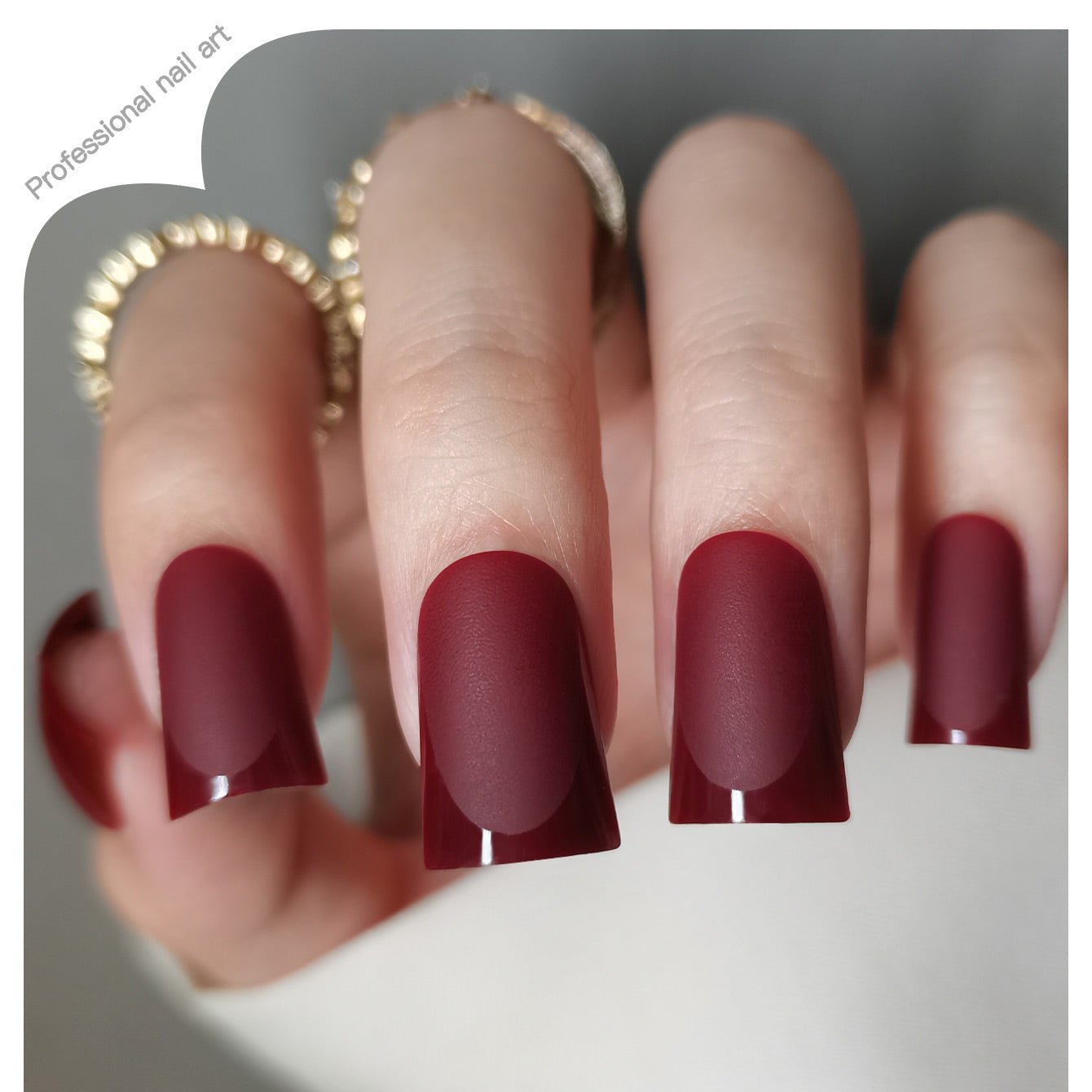 Ruby Tip Charm M Duckbill press-on nails worn on a hand