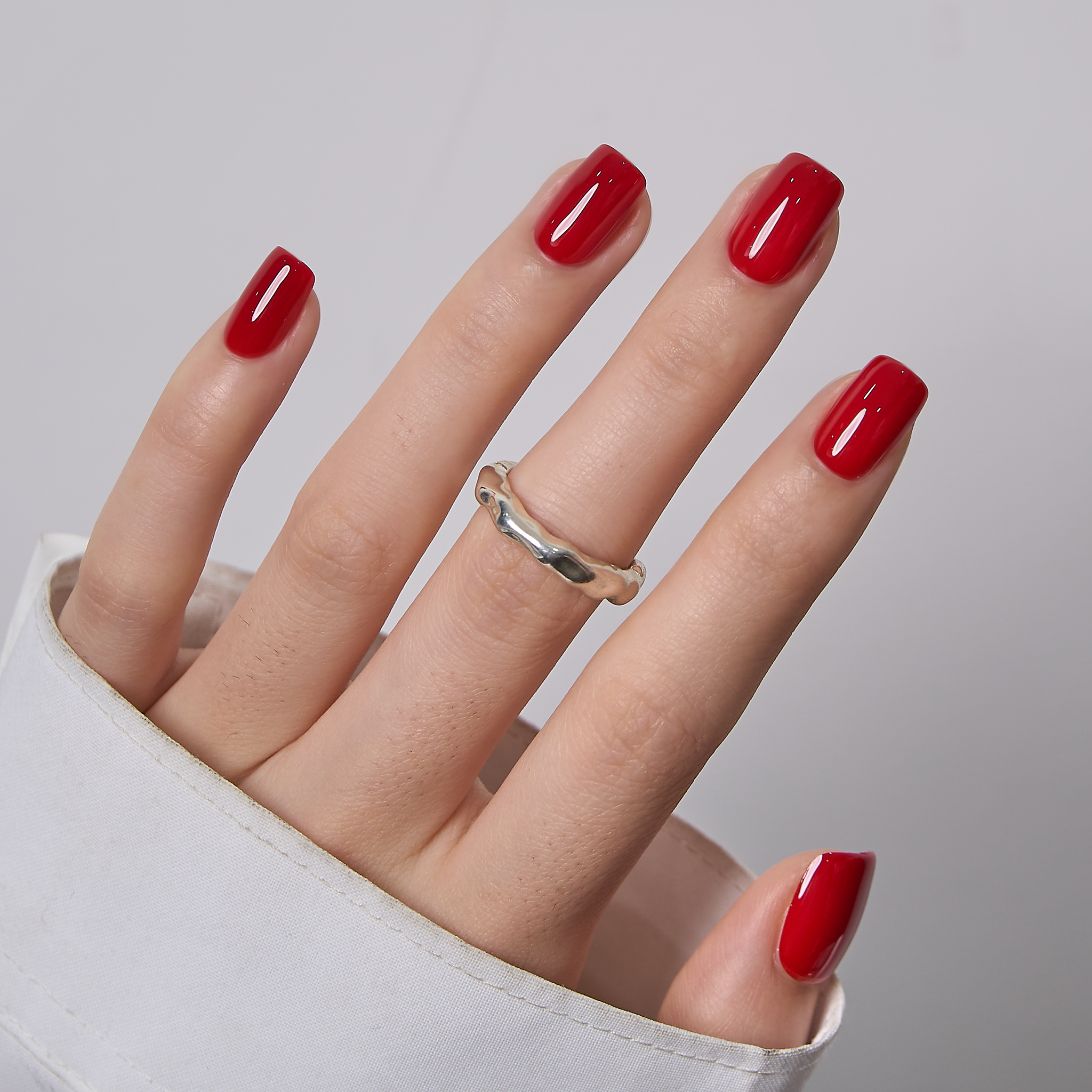 Ruby Winter short squoval press-on nails worn on a hand