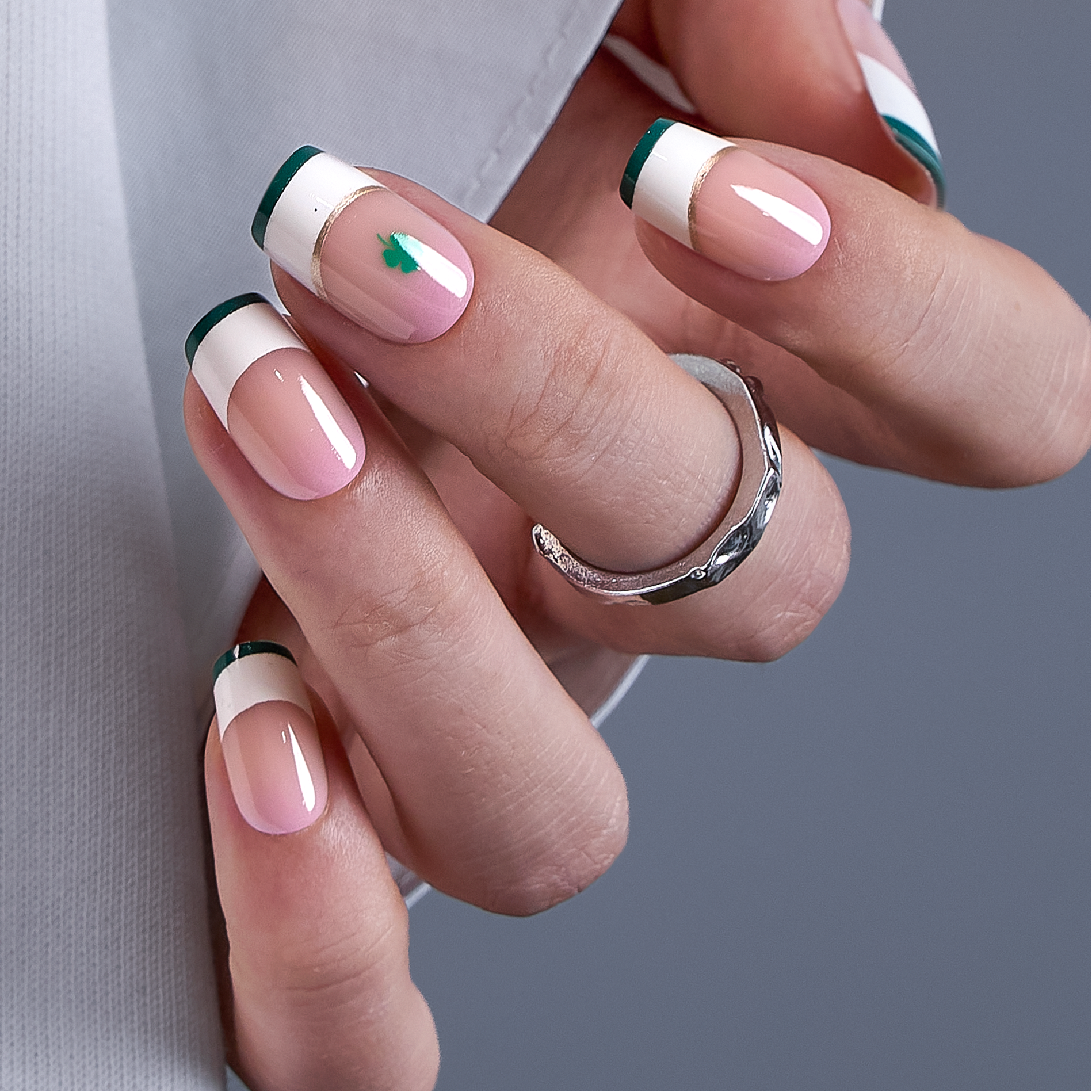Shimmer Clover medium squoval press-on nails worn on a hand