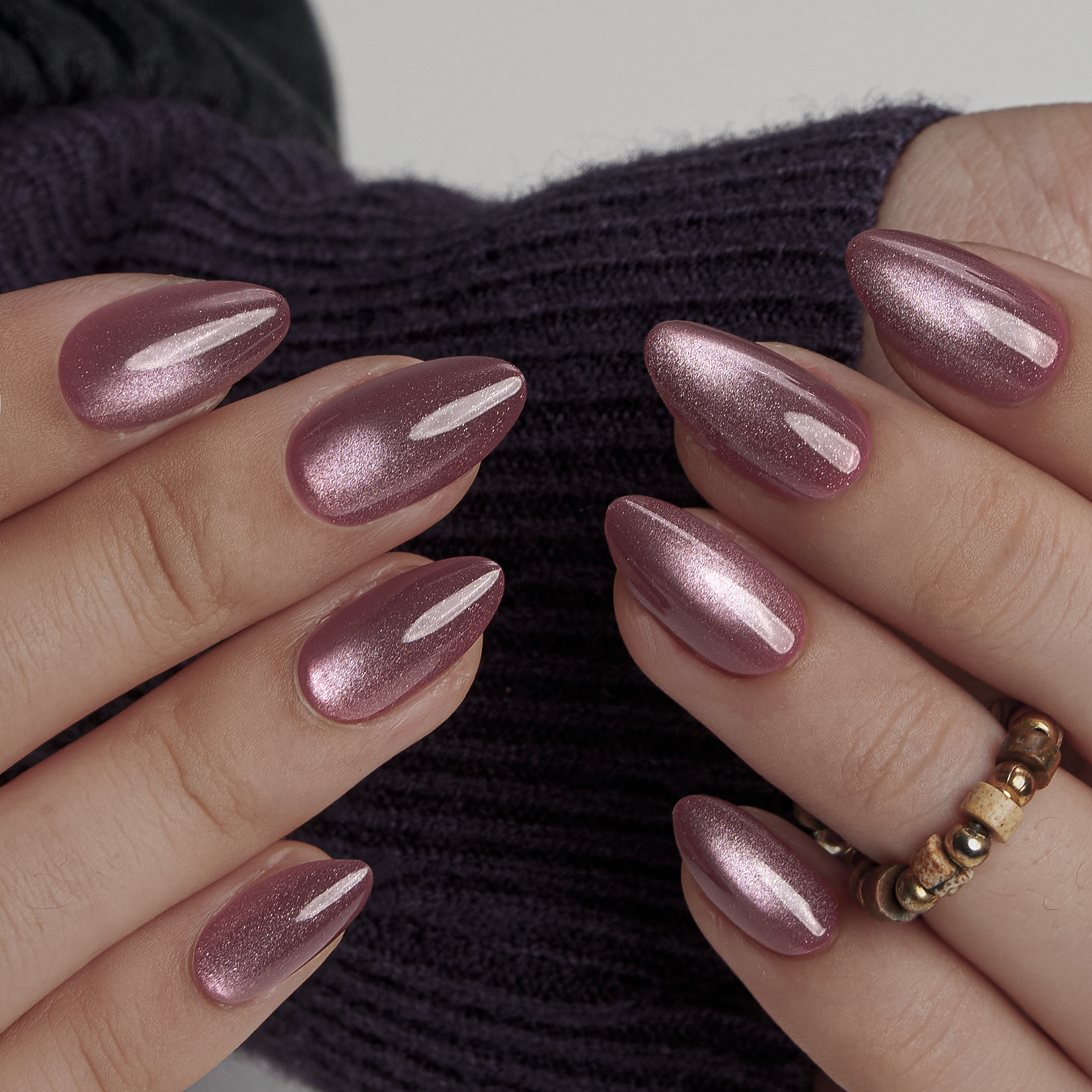 Shimmering Bliss short almond press-on nails worn on a hand