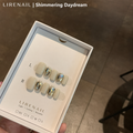 Shimmering Daydream press-on nails packaging with cream base, frosted silver edge and clear crystal accents