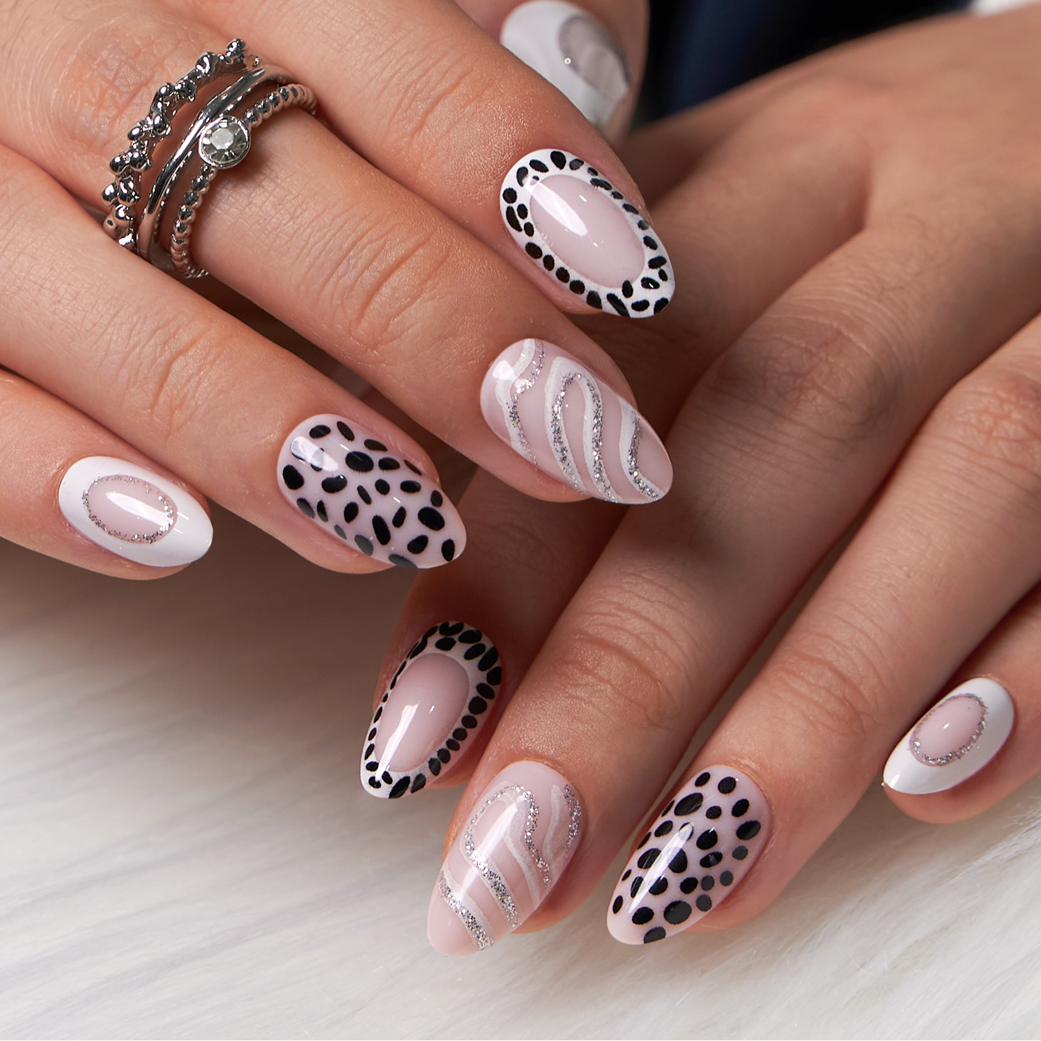Silver Line Chic short almond press-on nails worn on a hand