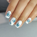 Sky Petals short squoval press-on nails worn on a hand