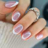 Snow Veil Rs almond press-on nails worn on a hand