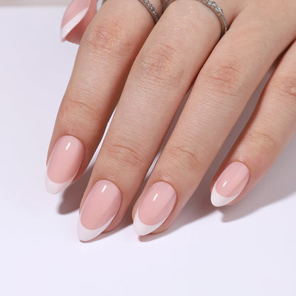 Soft French Glow short almond press-on nails worn on a hand