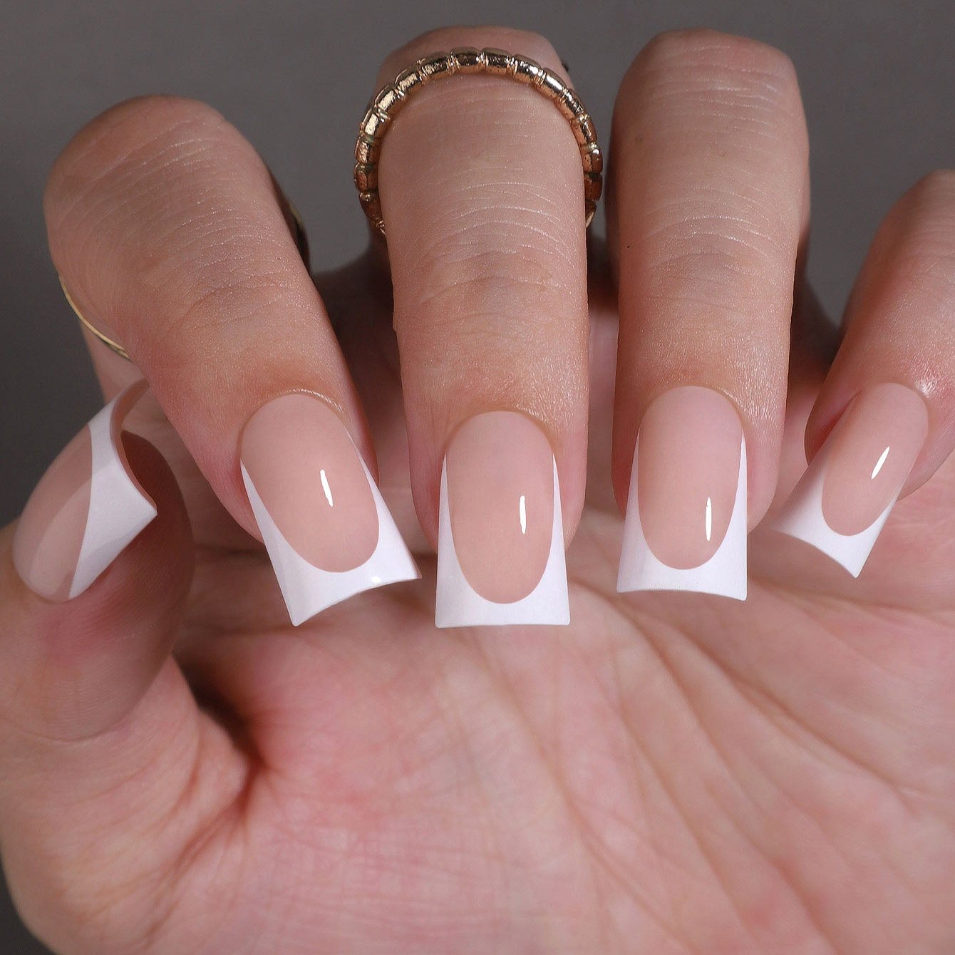 Soft Ivory Tips M Duckbill press-on nails worn on a hand