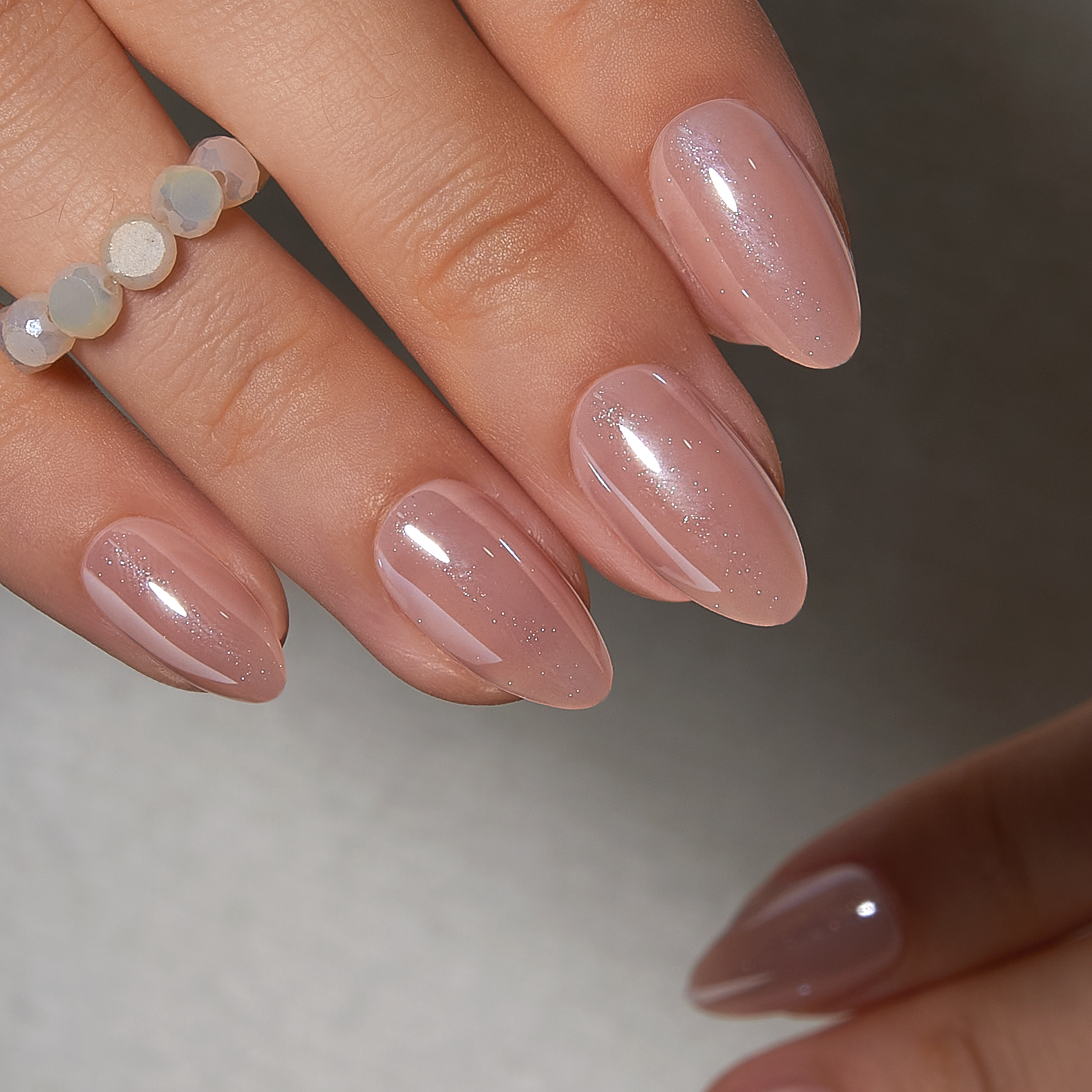 Soft Nude Charm short almond press-on nails from the side