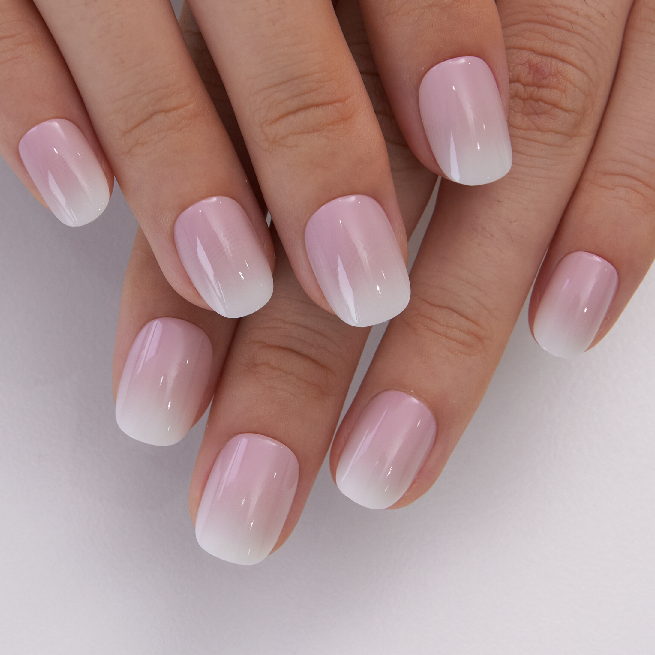 Soft Petal Glow Rs squoval press-on nails worn on a hand