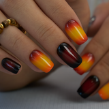 Sunset Flame medium squoval press-on nails worn on a hand