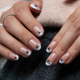 Sweet Knot short oval press-on nails worn on a hand