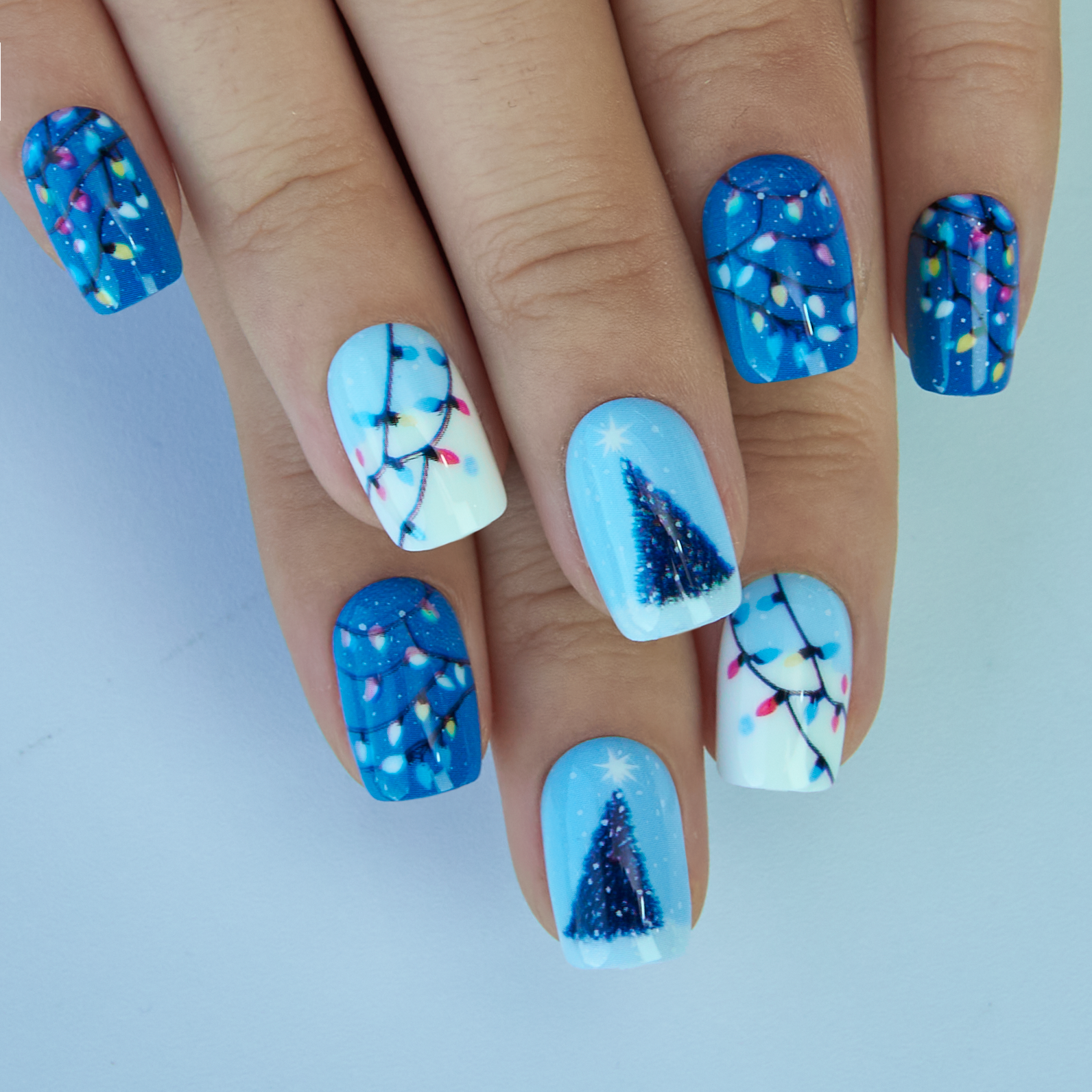 Twinkle Night short squoval press-on nails worn on a hand