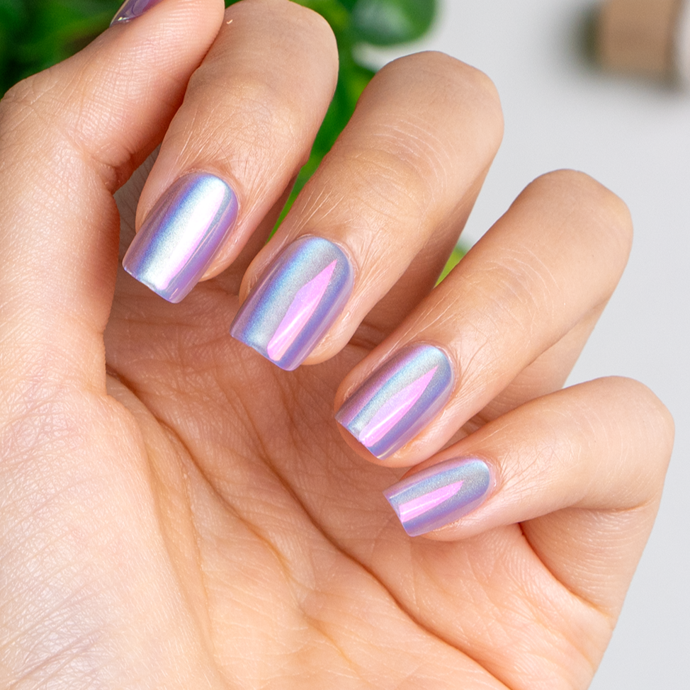 Unicorn Glow short squoval press-on nails worn on a hand