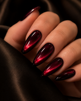 Velvet Merlot Cat Eye long almond press-on nails worn on a hand