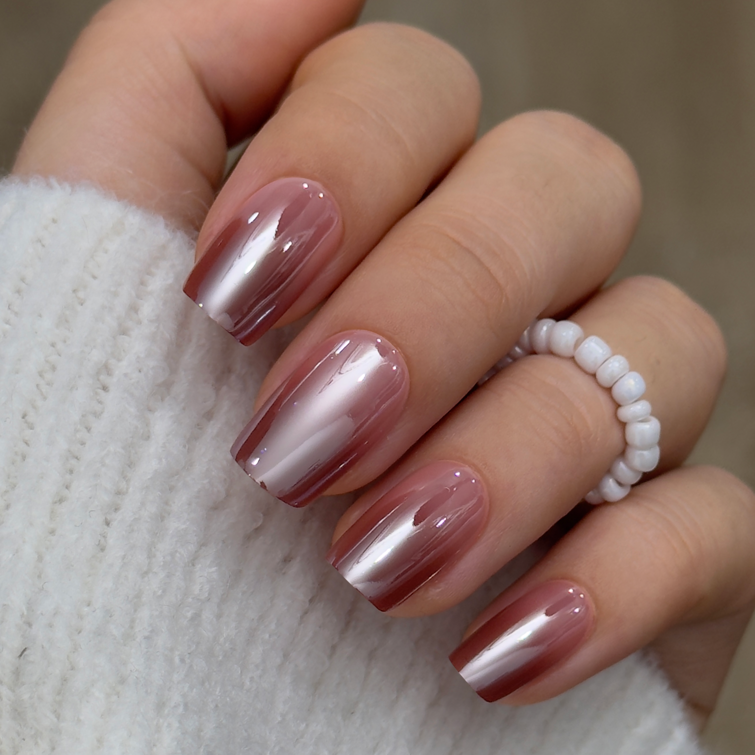 Warm Gradient medium squoval press-on nails worn on a hand