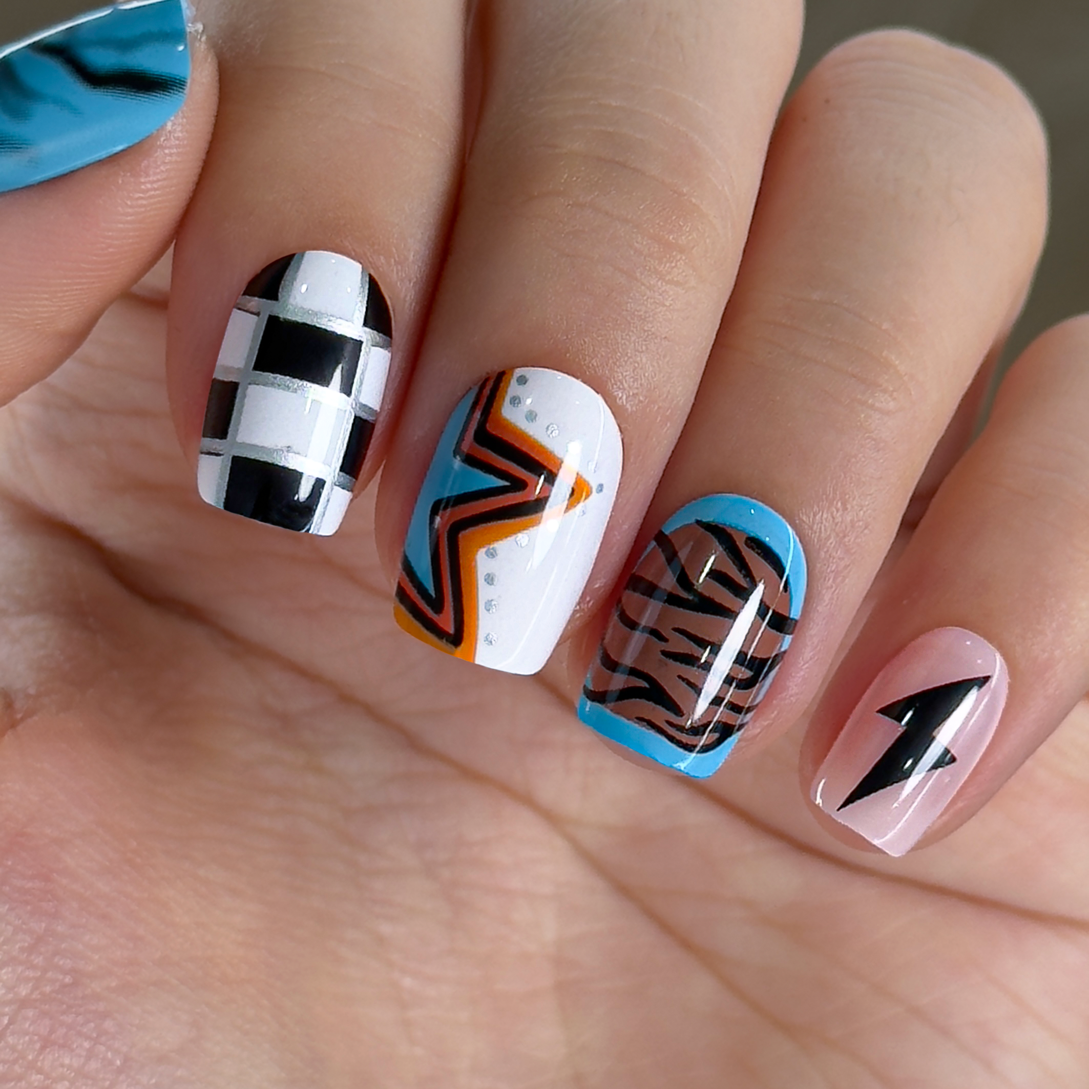 Western Leopard short squoval press-on nails worn on a hand