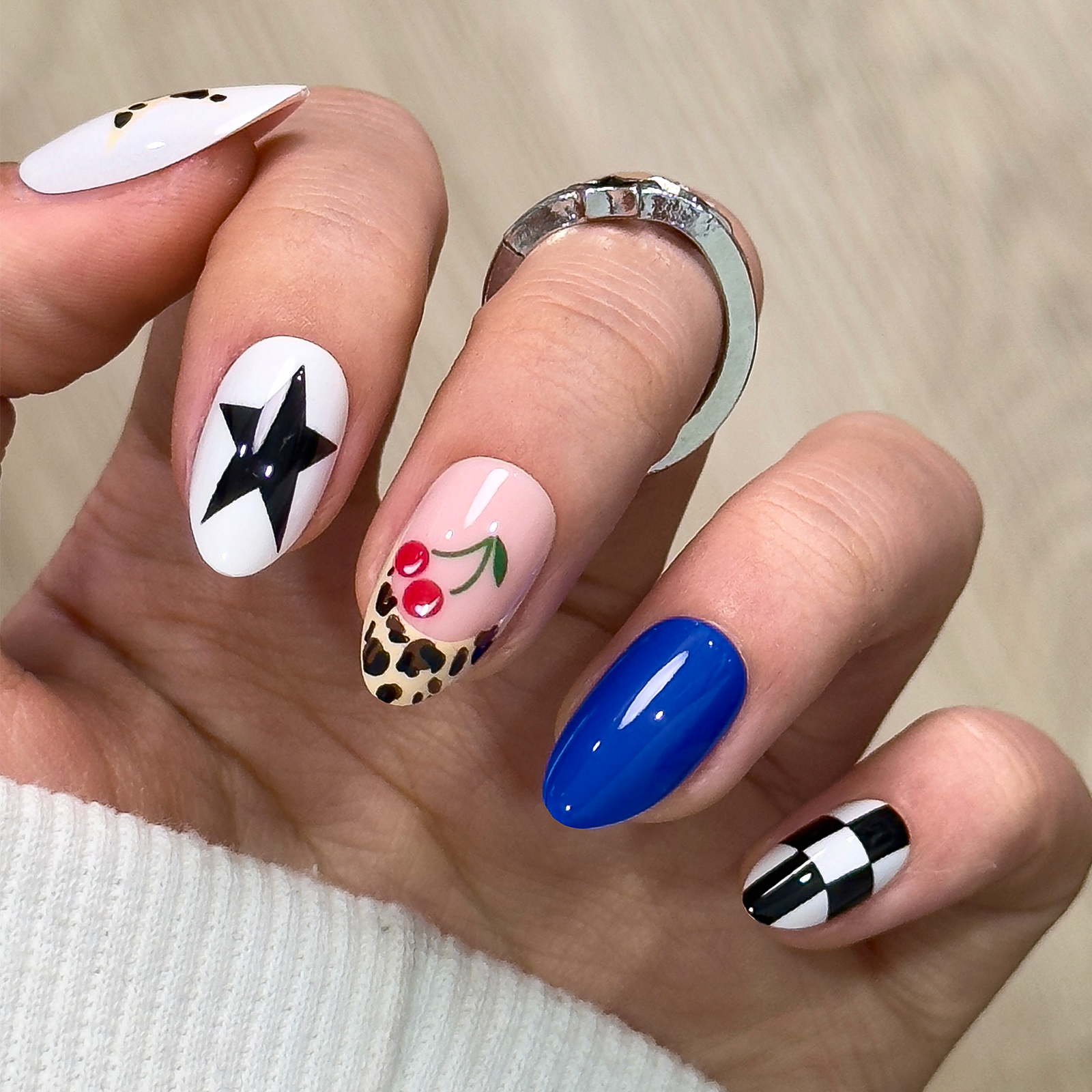 Western Star short almond press-on nails worn on a hand