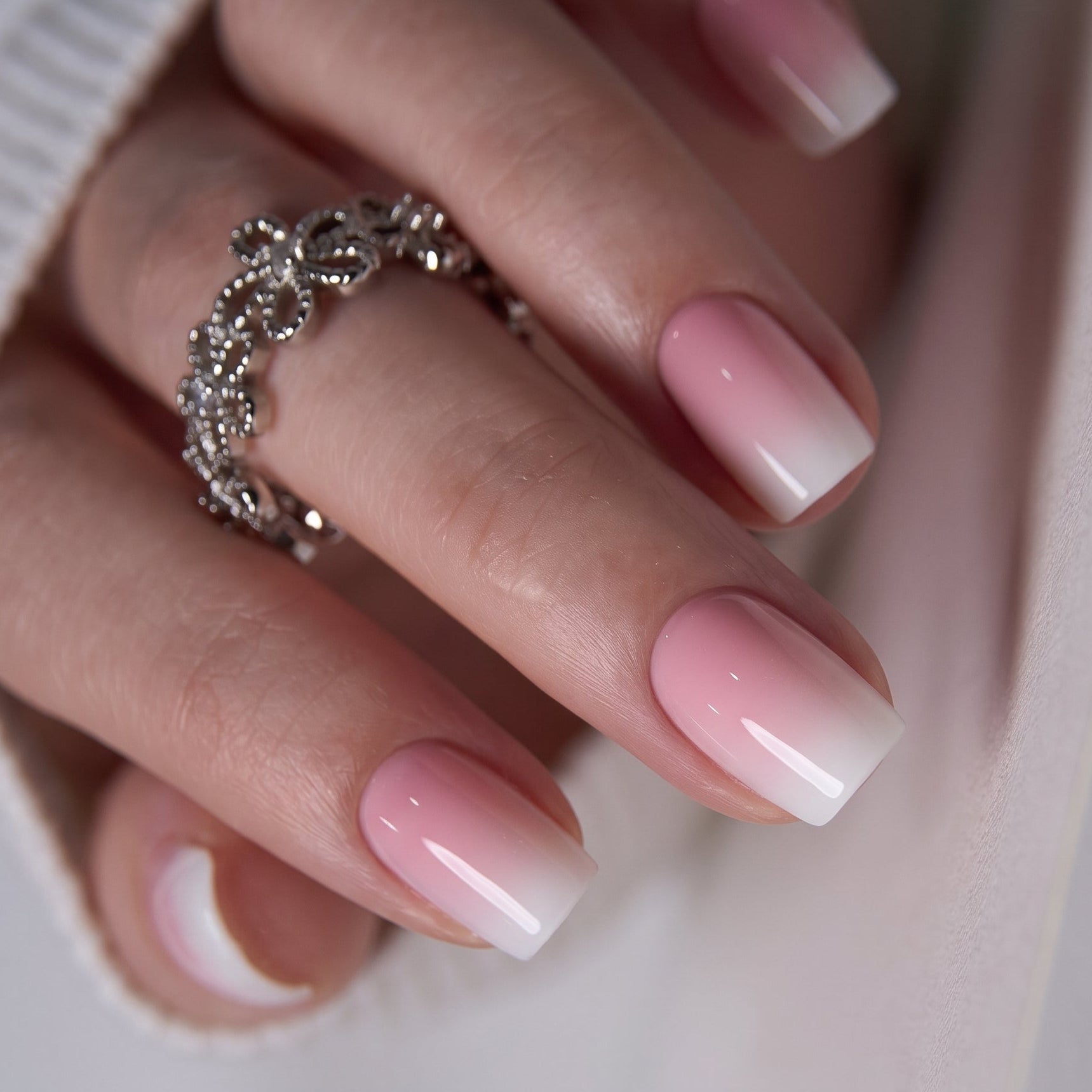 White Peach medium squoval press-on nails worn on a hand