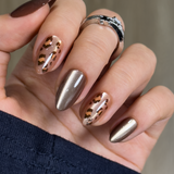 Wild Amber Dream short almond press-on nails worn on a hand